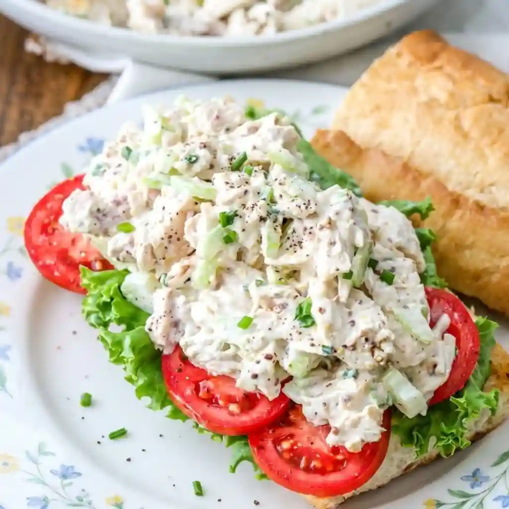 The Chicken Salad Recipe I Meal-Prep Every Week 2 Creamy chicken salad sandwich with lettuce, tomato slices, and herbs on toasted bread